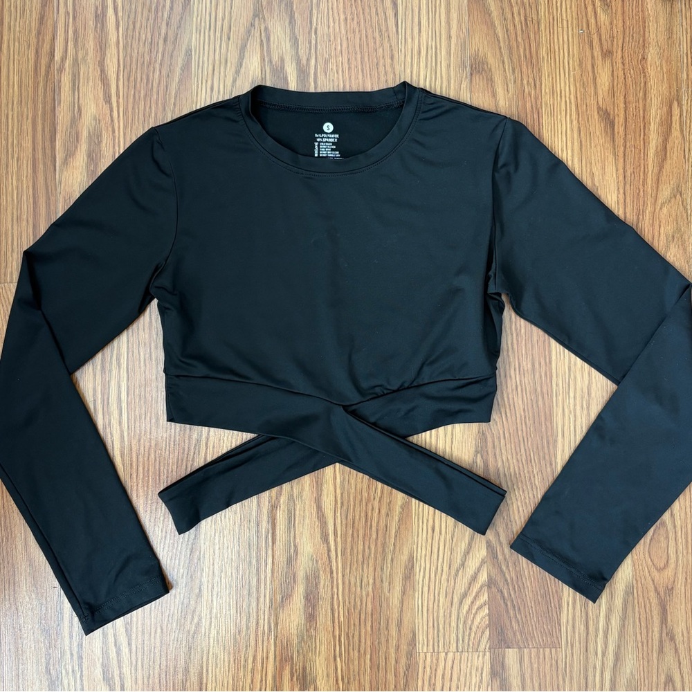 NVGTN cropped workout top with cross detailing at waist